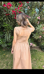 Shadow & Shine Desert Muse Maxi Dress in tan, featuring a smocked bodice, cutout back, and flowy skirt. Model is outdoors.